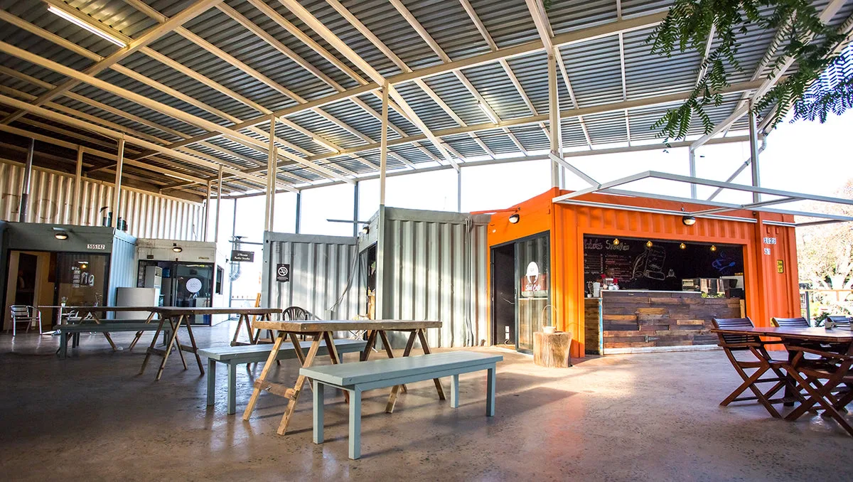 Modified shipping container with windows and doors