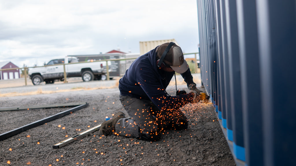 Cascade Vaults' Team Member Modifying A Shipping Container